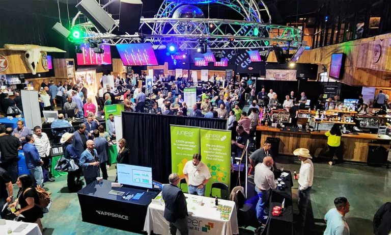 Trade show floor at Stampede with vendor booths and attendees