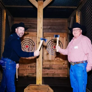Guests posing with axes at Imagen Venues, a turn-key corporate event venue in Houston