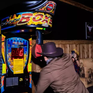 Guest playing boxer arcade machine at Imagen Venues, a corporate event venue in Houston