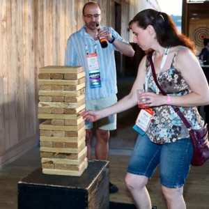 Guests playing giant Jenga at Imagen Venues, a turn-key corporate event venue in Houston