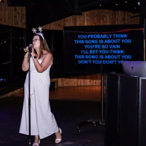Guest singing karaoke at Imagen Venues holiday party in Houston corporate event venue