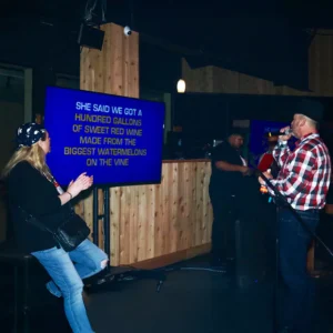 Guest singing karaoke at Imagen Venues, a turn-key corporate event venue in Houston
