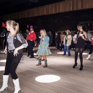 Guests participating in line dancing at Imagen Venues, a turn-key corporate event venue in Houston