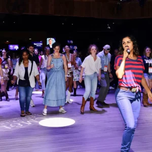 Instructor leading line dancing with guests at Imagen Venues corporate event venue in Houston