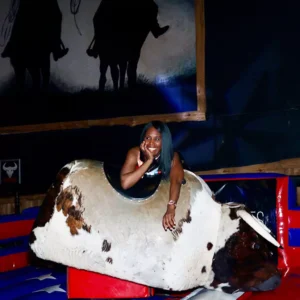 Guest enjoying a mechanical bull ride at Imagen Venues, a turn-key corporate event venue in Houston