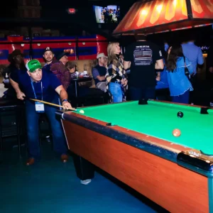 Guest playing pool during a corporate party at Imagen Venues in Houston