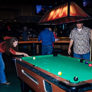 Guests playing pool during a corporate event at Imagen Venues in Houston