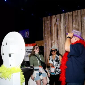 Guests using props at the photo booth during a seamless corporate event at Imagen Venues in Houston