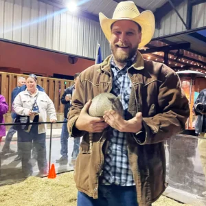 Guest holding an armadillo at Imagen Venues, a turn-key corporate event venue in Houston