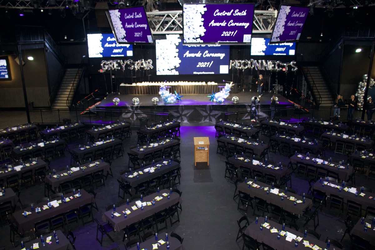Greystar awards ceremony at Escapade Event Center with branded screens, stage, and banquet seating