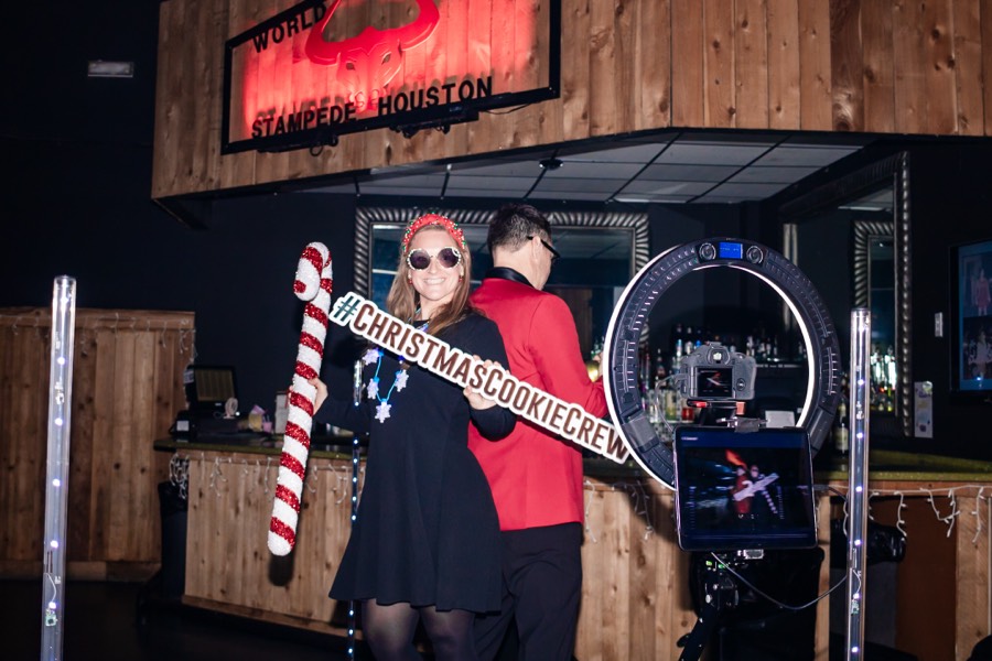 Couple on the 360 photo booth platform at a Houston company holiday party